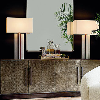 Two Table Lamps with Mirror Between Displayed On Credenza